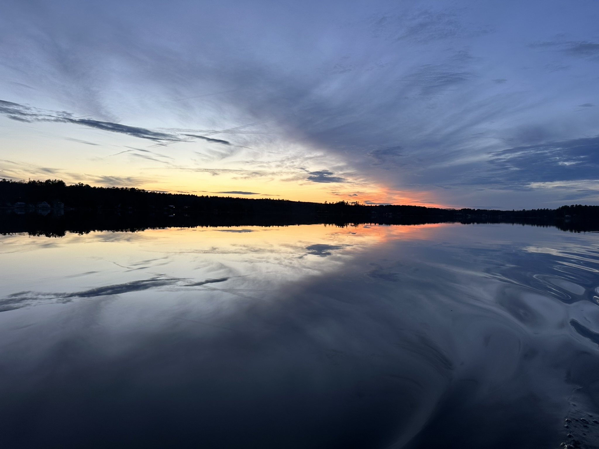 Sunset over Threemile Pond with broad reflections across calm water